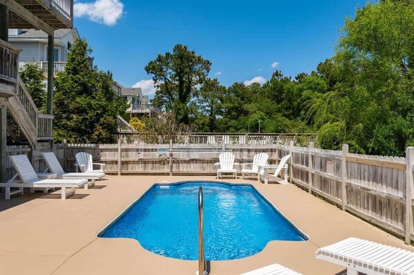 Dive into paradise at Yellow Lotus's outdoor entertaining area, featuring a fenced private pool with inviting pool loungers, a bubbling hot tub, and a sizzling gas grill for al fresco feasts. Enjoy endless fun with the playground and outdoor games. 