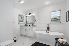 Master bathroom with new modern soaker tub, double vanity and separate shower
