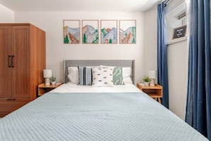 Large wardrobe, nightstands & reading lights on both sides of the queen bed.