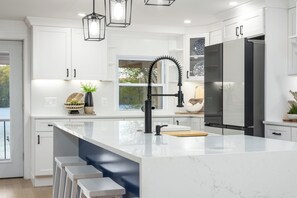 A spacious, gourmet kitchen fully stocked for all your cooking needs.