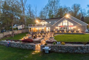 Elegant lakefront retreat with glowing pathways and stunning outdoor space