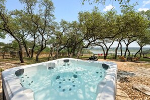 Soak in the hot tub with beautiful lake views—relax and unwind at Sunrise Lodge on Lake Travis.