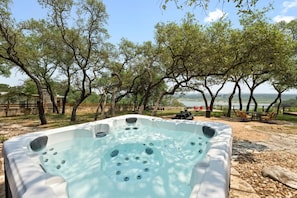 Soak in the hot tub with beautiful lake views—relax and unwind at Sunrise Lodge on Lake Travis.
