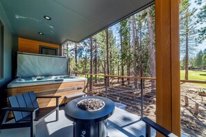 Private deck off main living area with gas fire pit and seating area.