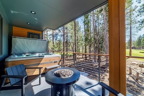 Private deck off main living area with gas fire pit and seating area.