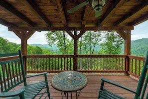 Start your morning with coffee or end your day with a glass of wine at this cozy balcony nook — complete with comfy seating and a charming table.