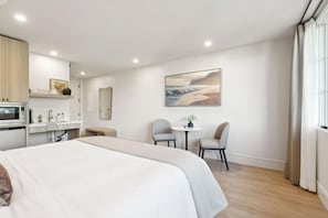 King-size bed, sleeps 2, seating area, and 65" Hisense TV