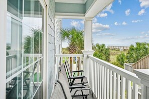 Sit outside and relax on this ocean view balcony and listen to the waves.