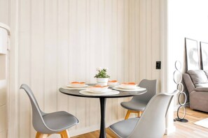 Enjoy breakfast or a quiet dinner in this light-filled dining corner, designed for both comfort and conversation.