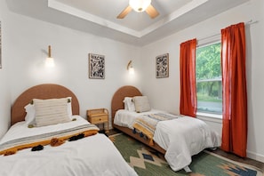 Relax in Bedroom 3, featuring two comfortable single beds for a restful stay.