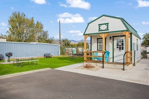 A photo of cabin 4 and the turf area beside it