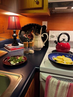 Kitchen with electric stove, top oven full refrigerator Keurig coffee maker.