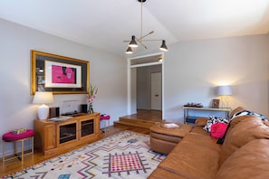 The large living room has classic barware, a turntable and vinyl.