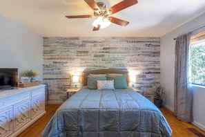 The main bedroom is an ocean of serene blues and greens.