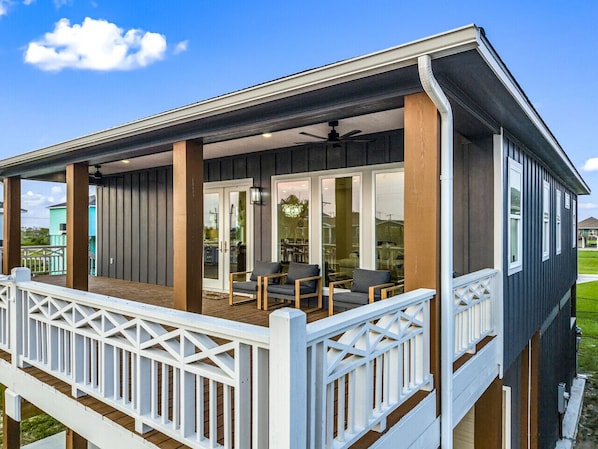 Stylish covered balcony with comfy seating, perfect for morning coffee or evening chats.