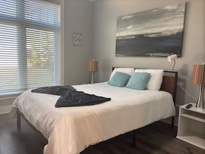 Bedroom Retreat: Tranquil space with vibrant decor and lovely natural light! Perfect for relaxation!
