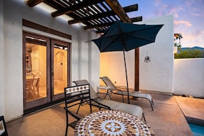 Patio with seating area by the pool