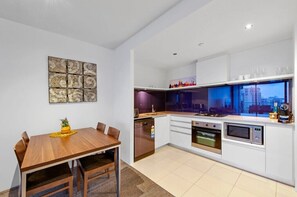 Dining area connected to a modern kitchen for easy access.