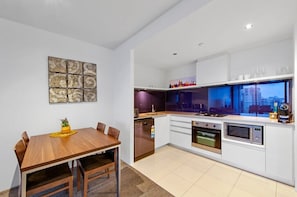 Dining area connected to a modern kitchen for easy access.