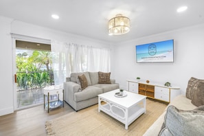 Spacious layout with smart TV, cozy seating, and dining for six—ideal for relaxing or hosting meals after the beach.