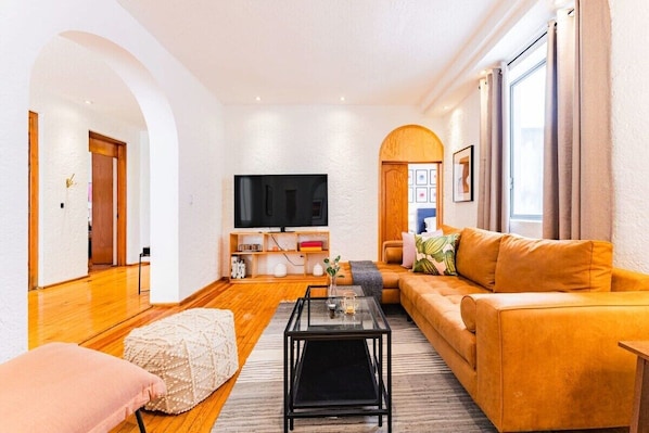 Inviting sitting area with a mustard-yellow sofa and stylish decor elements.