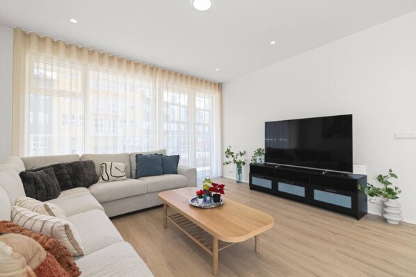 Living area w/ 65"inch TV & Big Sofa