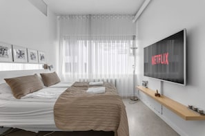 Luxury awaits in the master bedroom, complete with a private bathroom, 65" TV, and the coziest bed you'll ever sleep in.
