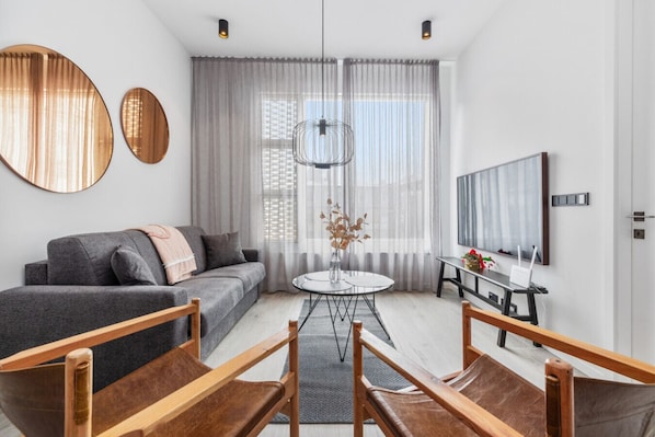 This cozy and stylish living room offers the perfect blend of modern sophistication and inviting comfort.