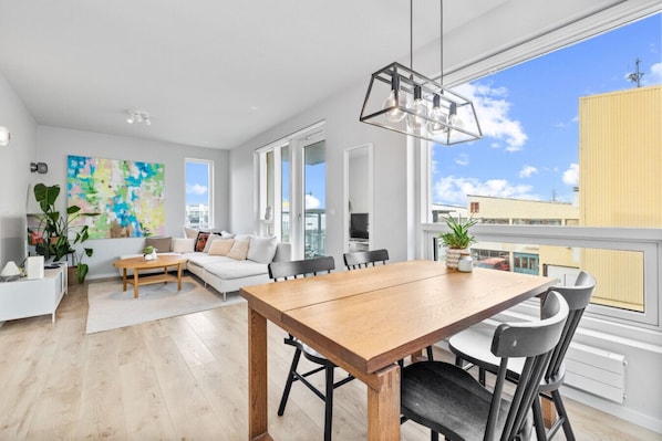Bask in the natural light that floods through the open-concept living space of this Reykjavik apartment, creating an inviting and airy atmosphere