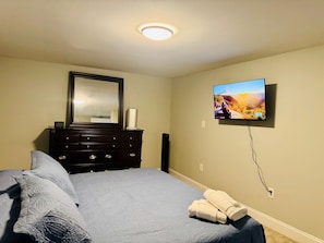 Bedroom space with 43 in Smart TV.