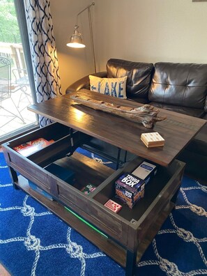 Table top lifts up to add another dining option. Board games are located inside.