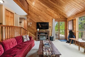 Living room with a 50" TV with cable & a DVD player, electric fireplace, and luxurious couches to kick back on after a day of adventures