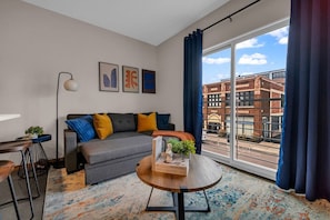 The living room is filled with natural light, creating a bright and welcoming space that invites relaxation.