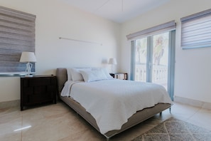 Tranquil Bedroom with a beautiful View – Wake up to natural light and step out to palm-framed views.