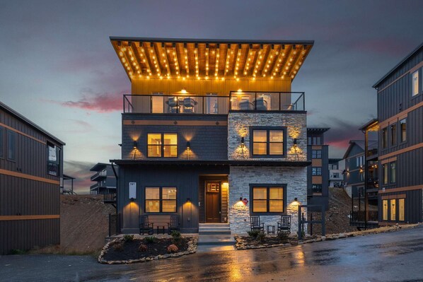 Stylish rooftop entrance with warm lighting and modern design.