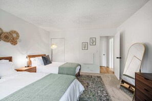 Second bedroom features 1 queen bed and 1 twin bed.