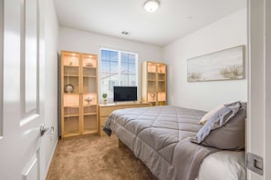First bedroom with queen bed and Smart TV