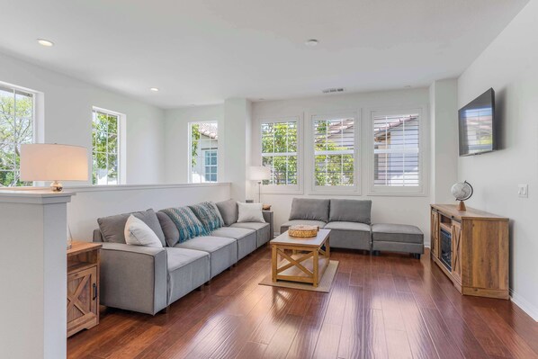 Spacious living room with Smart TV and lots of natural light