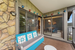 Private balcony with outdoor seating and treed lake views.