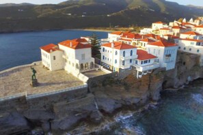 Birdseye view of the picturesque, centuries-old seaside town on the Andros peninsula with our Boutique B&B in focus with the large balconies overlooking the sea.