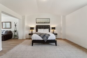 Stylish bedroom with a sleek bed, soft lighting, and a cozy, minimalist vibe.