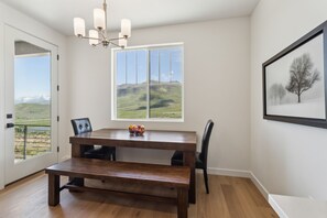 Inviting dining space with warm wood tones, comfy seating, and stunning mountain views.