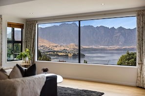 Dramatic views of Lake Wakatipu and The Remarkables—perfect for relaxing with a wine in hand.