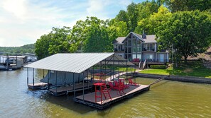 Soak up the lake life on your private dock featuring a 10x24 boat slip, lounge chairs, and a diving platform