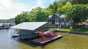 Soak up the lake life on your private dock featuring a 10x24 boat slip, lounge chairs, and a diving platform