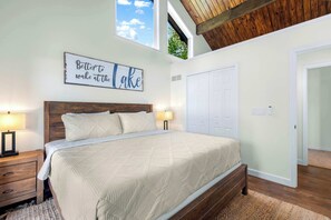 Vaulted ceilings and stunning lake views make this bedroom a true retreat. 