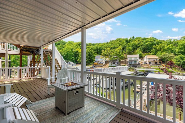 Deck with Adirondack chairs and a gas fire pit—perfect for cozy evenings and lakeview lounging