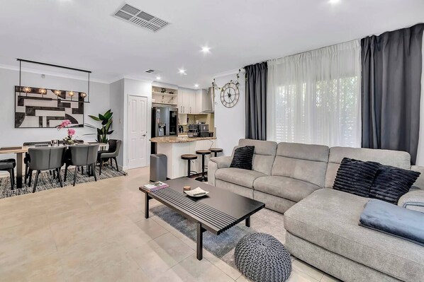 Enjoy effortless open-plan living that moves seamlessly from movie marathons to shared meals, all set against a backdrop of elegant design touches throughout.