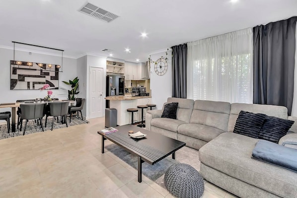 Enjoy effortless open-plan living that moves seamlessly from movie marathons to shared meals, all set against a backdrop of elegant design touches throughout.
