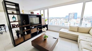 Experience modern and sophisticated living in the well-appointed living room. The stylish decor and contemporary design create an inviting space for relaxation and dining.